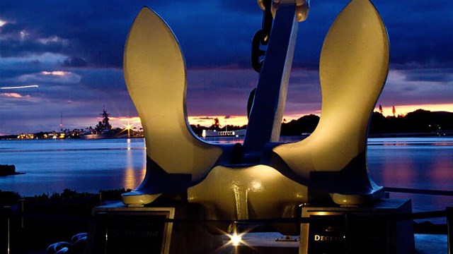 USS Arizona Memorial anchor with sunset in the background.