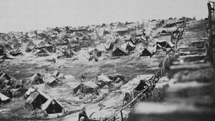 a black and white of a tent camp during civil war