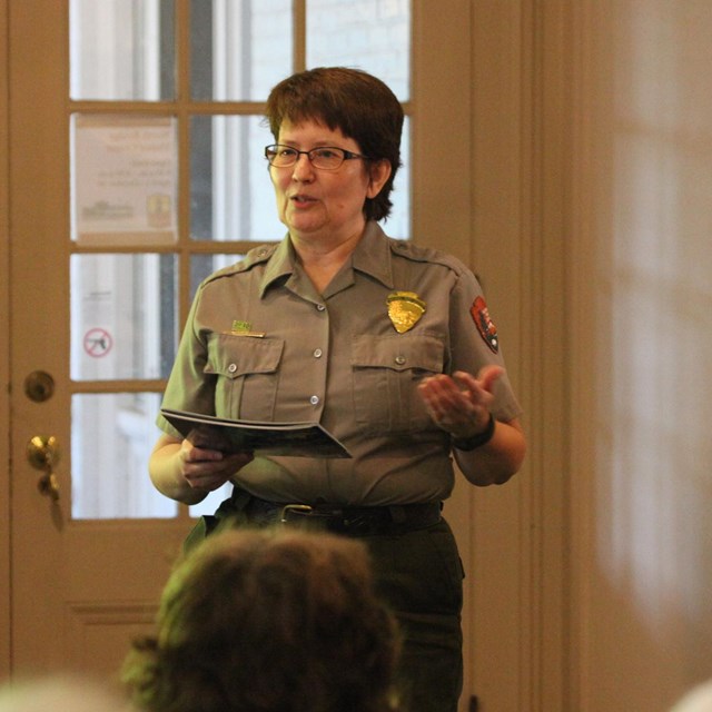 Park Ranger Michelle addresses an audience at North Bridge Visitor Center