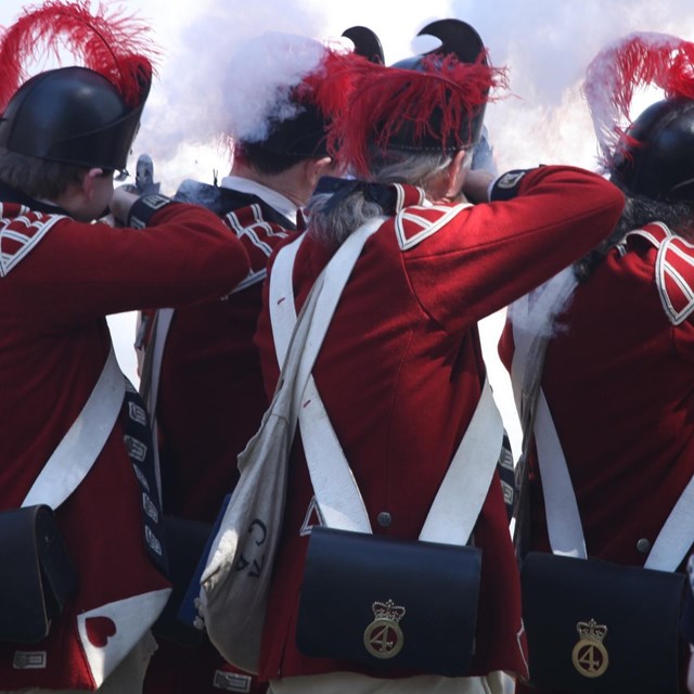 British reenactors fire a volley during the Battle Road tactical demonstration.