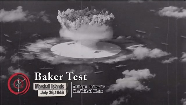 Screen shot of exhibit film showing a mushroom cloud explosion at sea