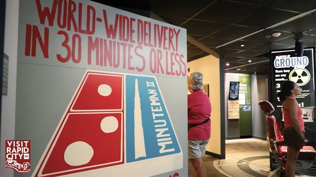 Big square door with a Domino's Pizza logo on it and a red chair behind it