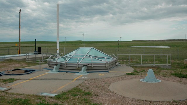 A concrete structure with a glass enclosure 