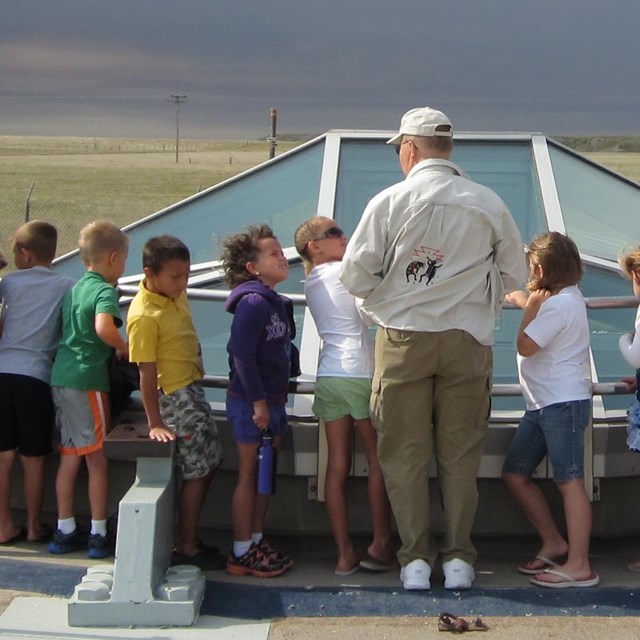 Students and a volunteer stand at the Delta-09 missile silo