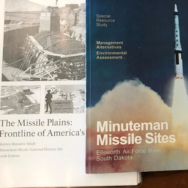 Three books on a desk