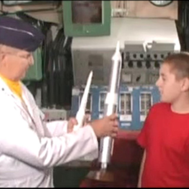 A missileer showing 2 missile models to a student