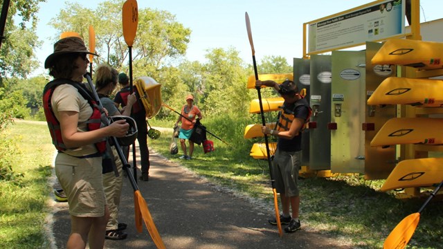 A river guide explaining how to use kayak paddles