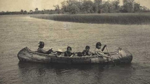 Women paddling a traditional canoe. 