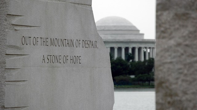 View of Jefferson Memorial between two stone walls of a memorial