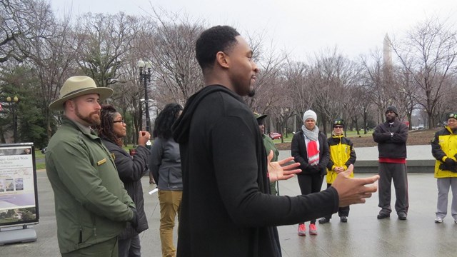 Man talking to a group and ranger