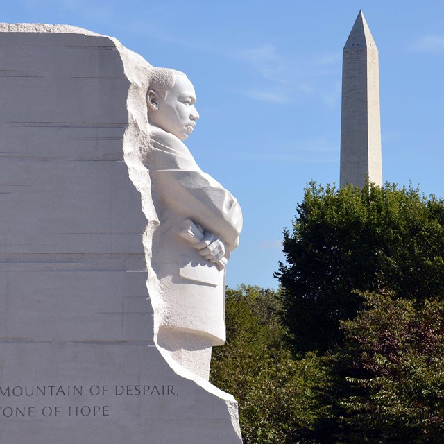 Statue of Martin Luther King Jr. with Washington Monument in the background