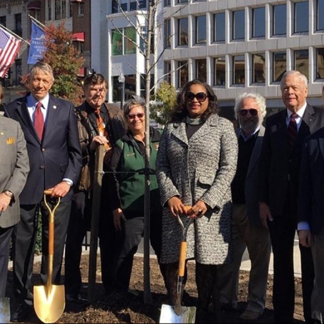 Group of National Park Service staff and partners holding ground-breaking shovels in a park