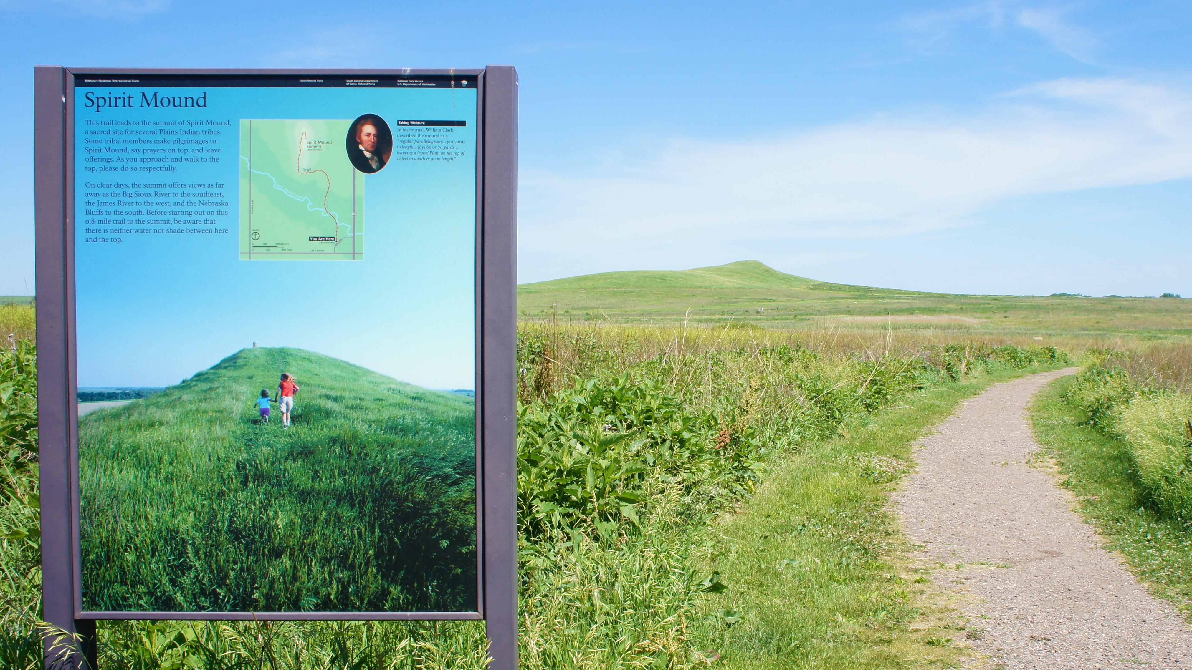 Trail leading into the grassland leads to Spirit Mound, an earthen mound covered in grass. 