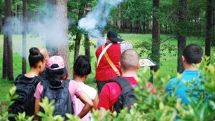 Ranger firing a musket for a school group