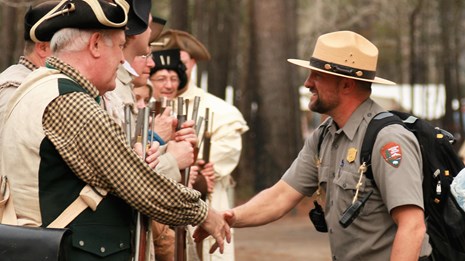 Ranger shaking hands with volunteer 