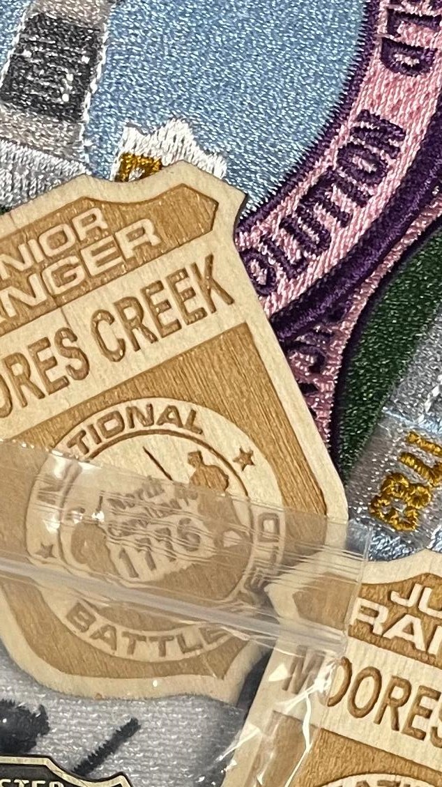 A close-up, slightly angled shot showcases a collection of embroidered patches