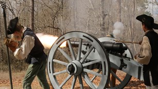 Minute Men firing a cannon. 