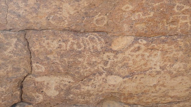 Petroglyphs seen on a large stone on the Hole-in-the-Wall Trail