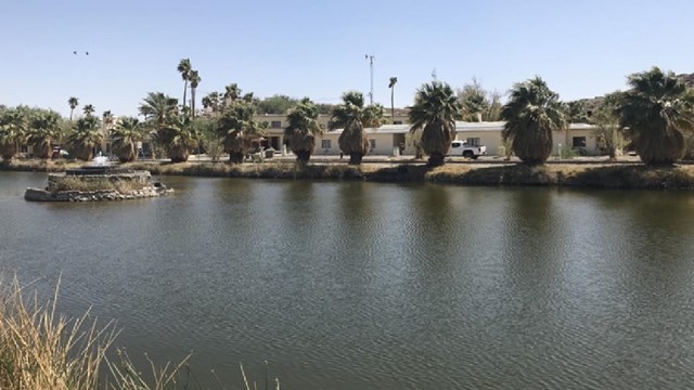 Lake Tuendae and water fountain with the Zzyzz Desert Studies Center in the background.