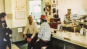 Historic picture of the Kelso Depot Lunch Counter as it appeared in the 1960s with 3 men.