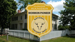 Junior ranger badge on a historic building.