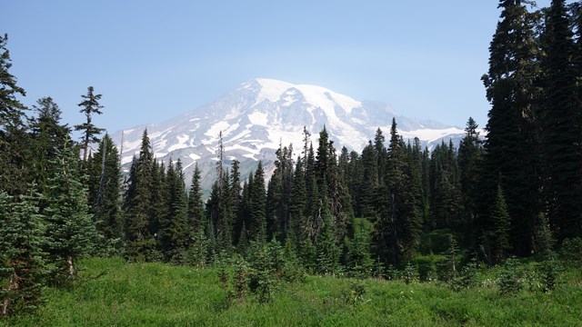 A view of Mount Rainier noticeably obscured by a hazy atmosphere.