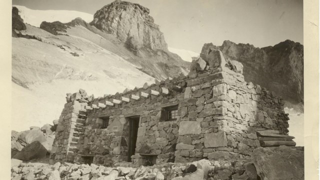 A stone building on a rocky mountainside