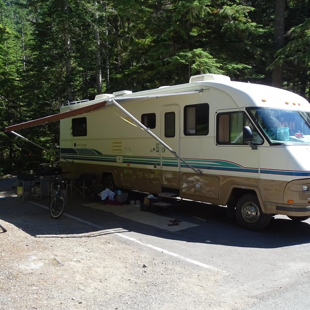 An RV parked at a campsite. 