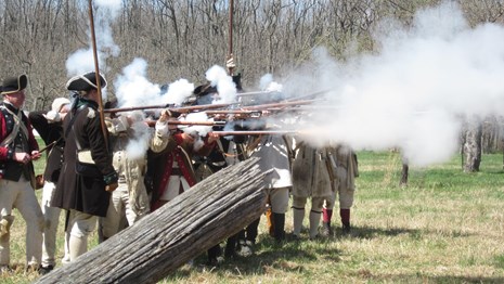 18th century army reenactment of musket fire