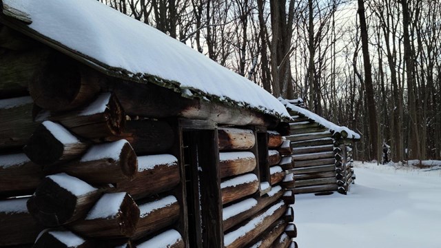 A log hut in a wintery snow