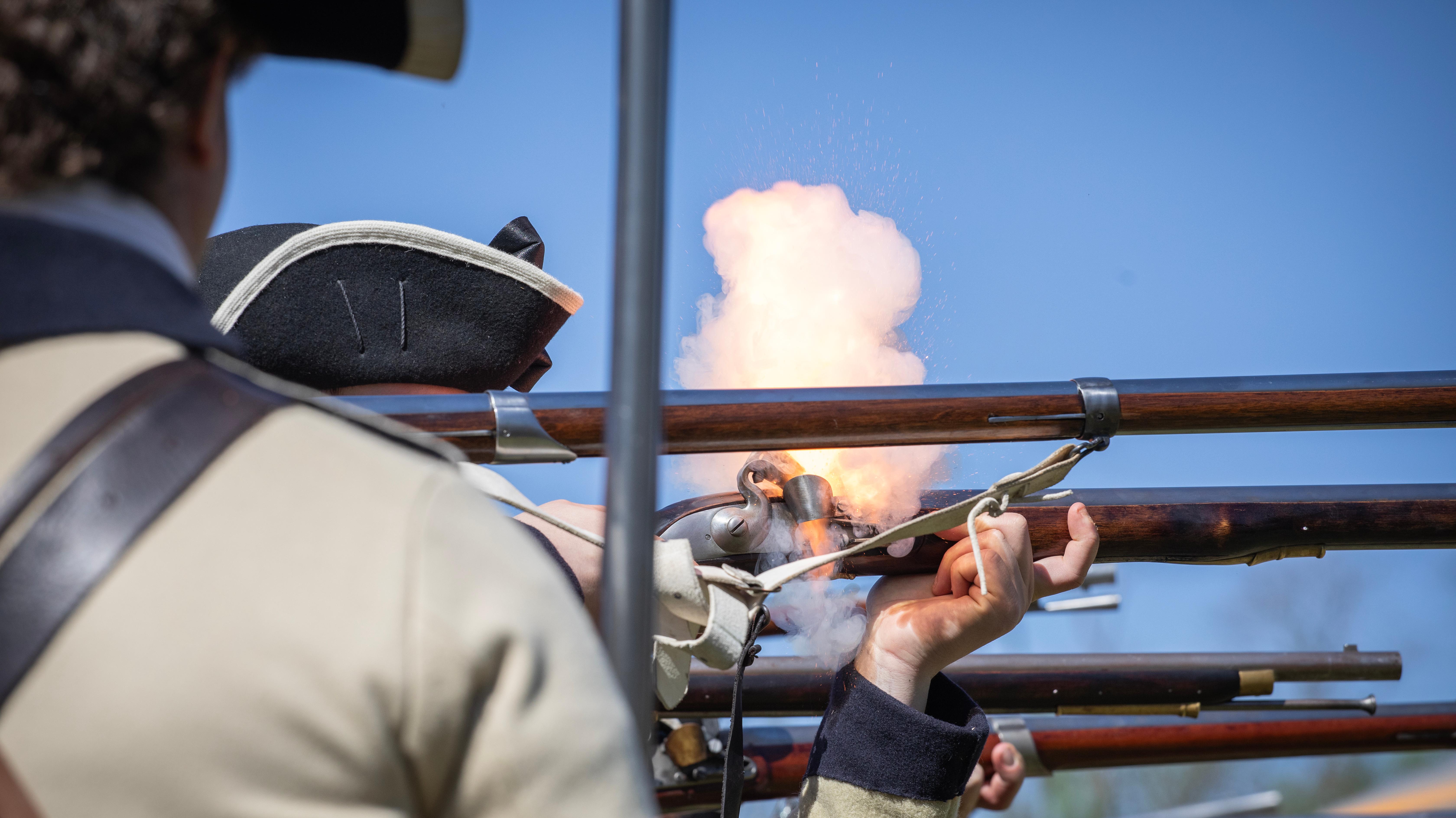 18th century army reenactment of musket fire