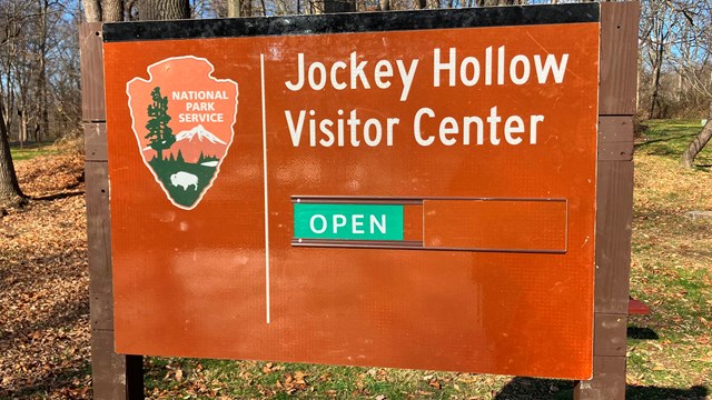 A sign for Jockey Hollow Visitor Center saying "OPEN"