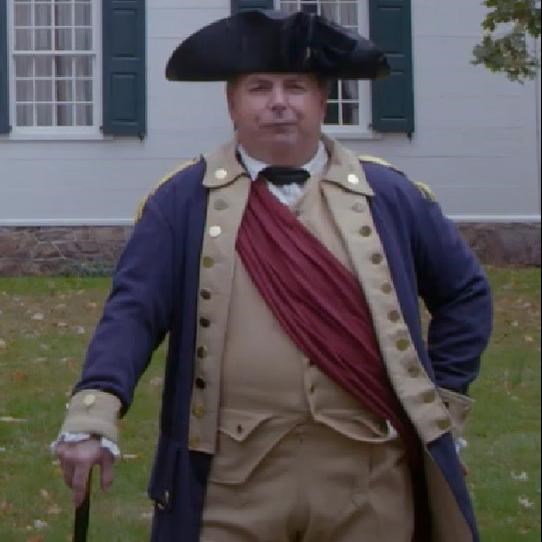 A man in continental officer's uniform outside of a mansion