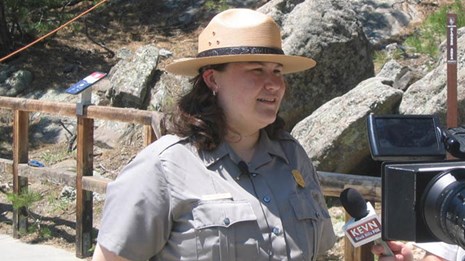 A park ranger being interviewed by local media.