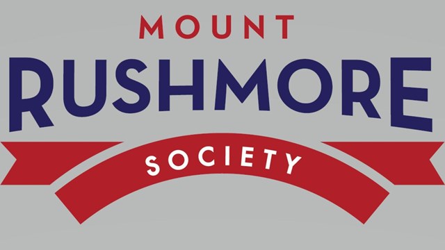 Red and blue stylized logo with the text "Mount Rushmore Society."