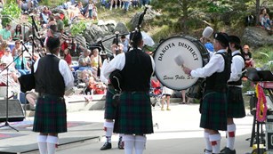 A group of bagpipers perform at Mount Rushmore.
