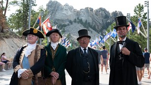 A group of bagpipers perform at Mount Rushmore.