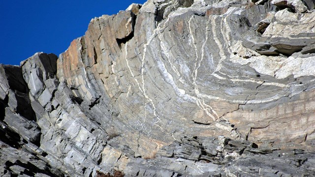 Folded rocks located below the sculpted faces on Mount Rushmore.