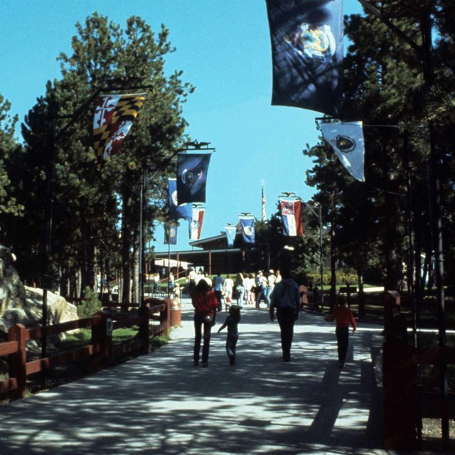 Walkway from the parking lot to the Visitor Center with the original Avenue of Flags.