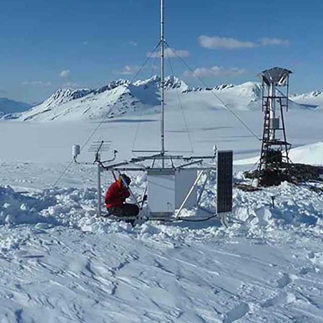 A weather station high in the mountains measures snowpack.