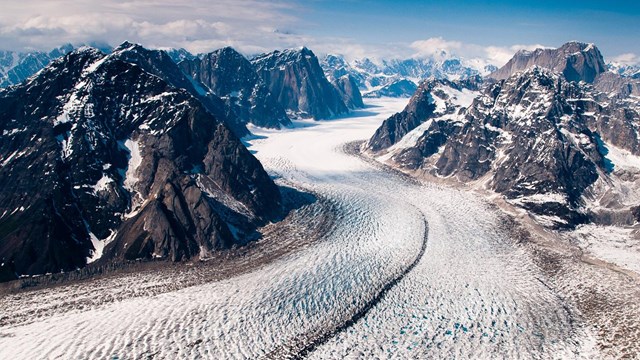 a glacier weaves through mountains