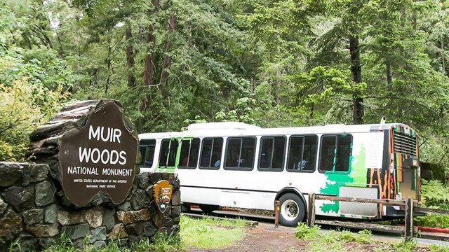 How has Muir Woods been lowering our visitation carbon footprint?