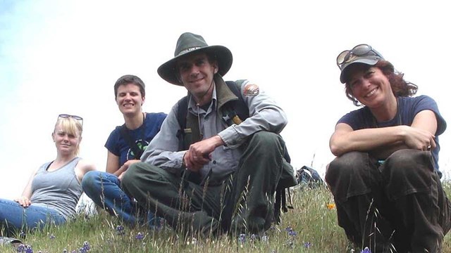 The natural resource management crew posing for a picture on a hillside.