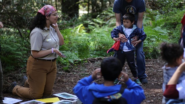 education ranger leads kids group in the woods