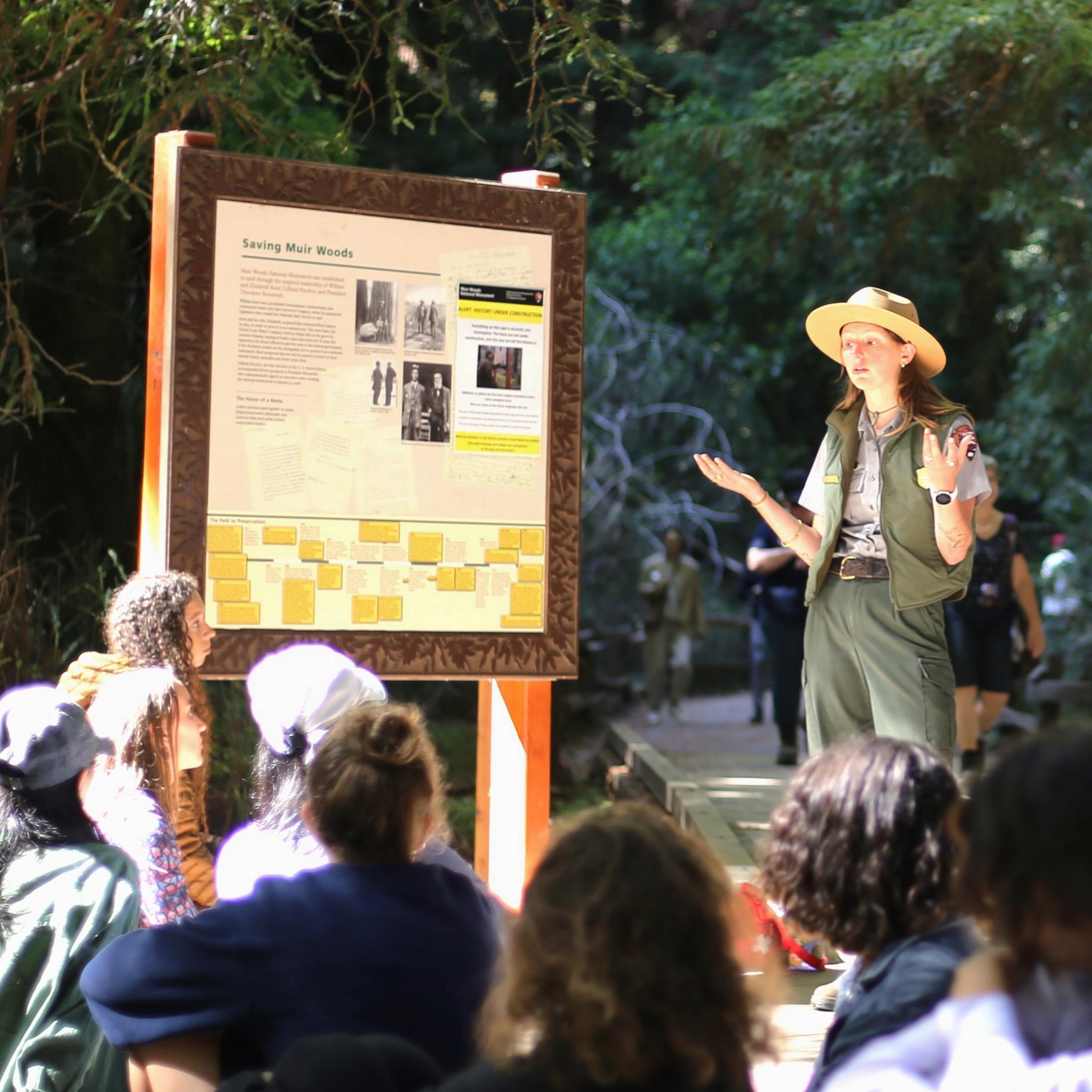 rangers talk with a group of students 