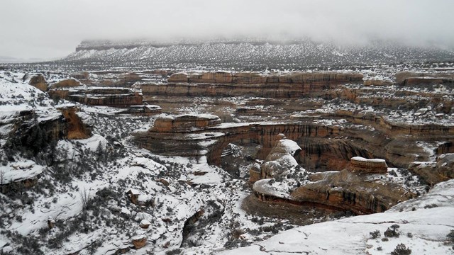 Sipapu natural bridge and surrounding landscape covered in snow