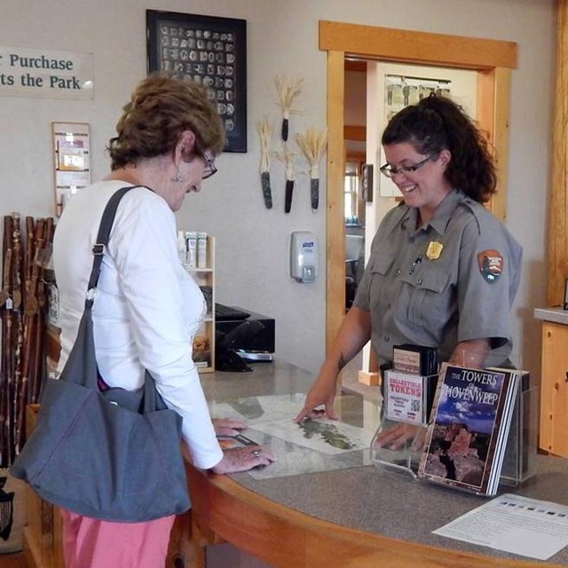 park ranger helping a visitor at the front desk