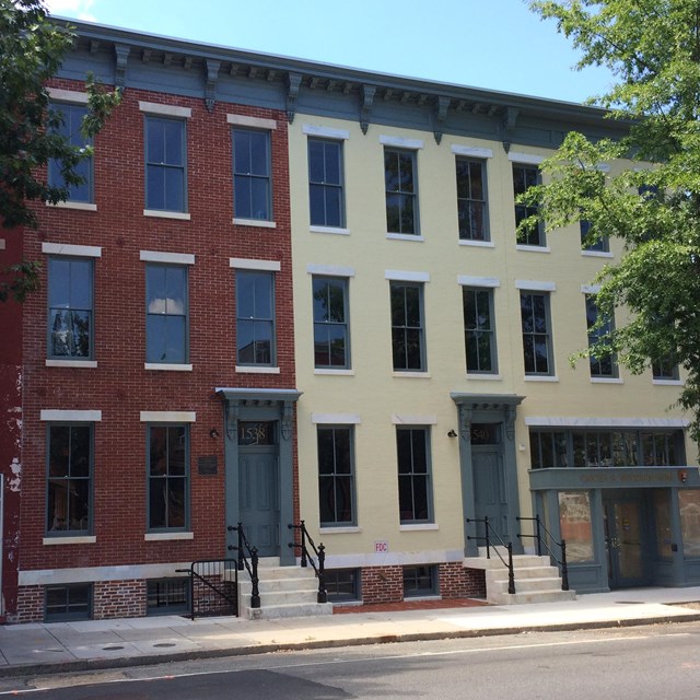 Three rowhouses on an urban street 