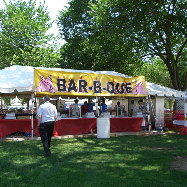 People near a large food tent