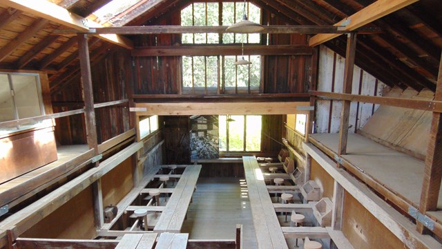 The barn/studio at Pond Farm Pottery, with rows of pottery stations and kickwheels.